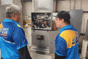 A team of AC repair techs working on an HVAC unit.